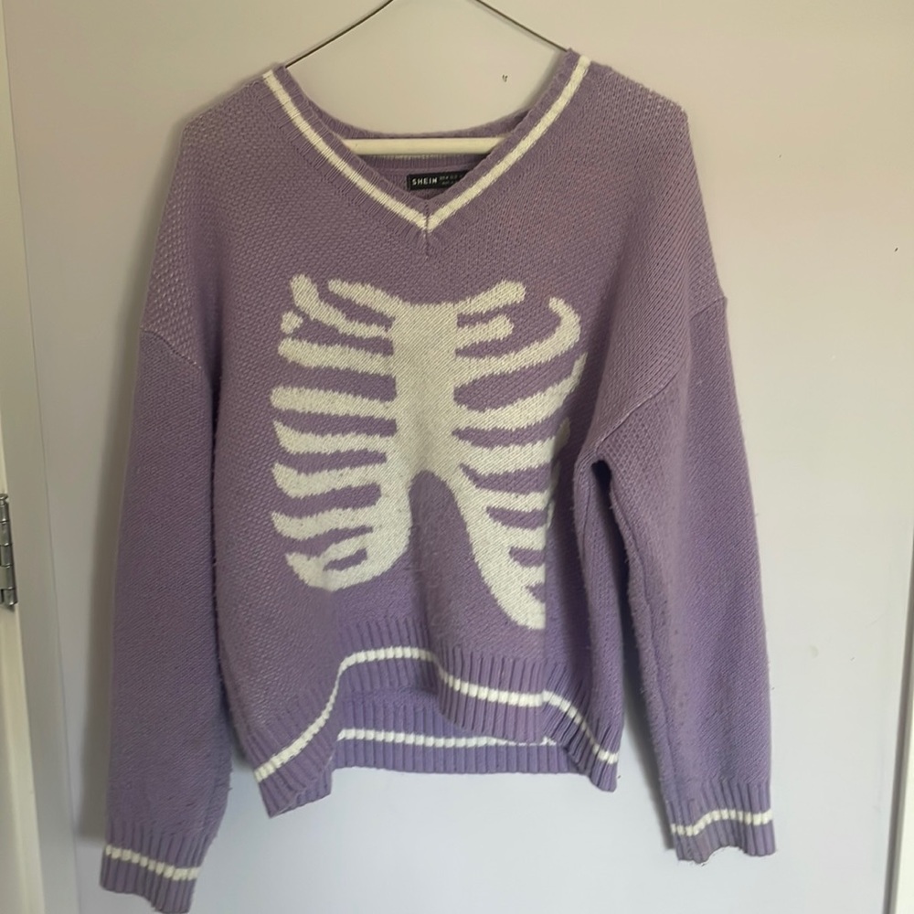 Women’s M purple knit sweater with ribcage motif.